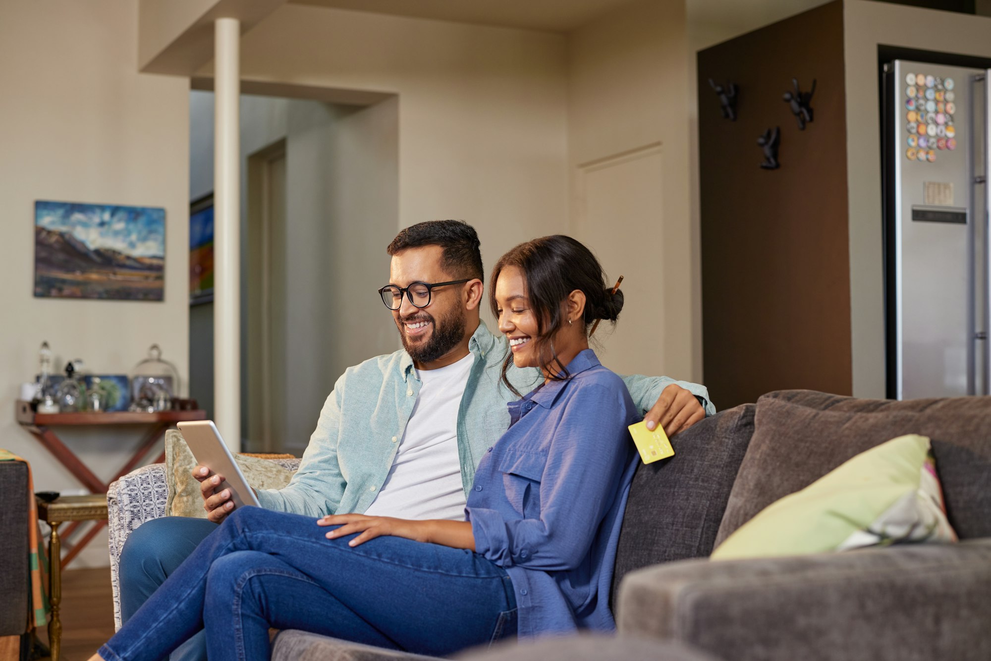 Multiethnic couple making online purchase with digital tablet