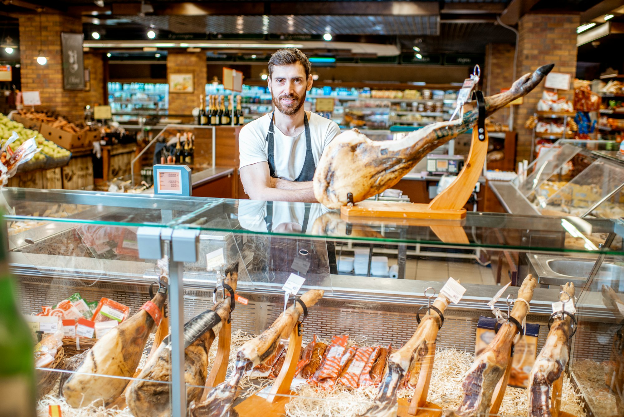 Seller with jamon in the supermarket